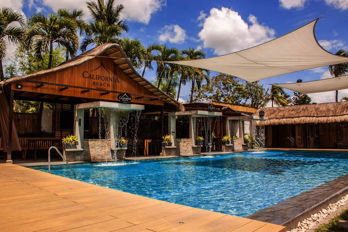 Tara Lets Anywhere feature — California Beach Pansol main pool with thatched pavilion and shade sails