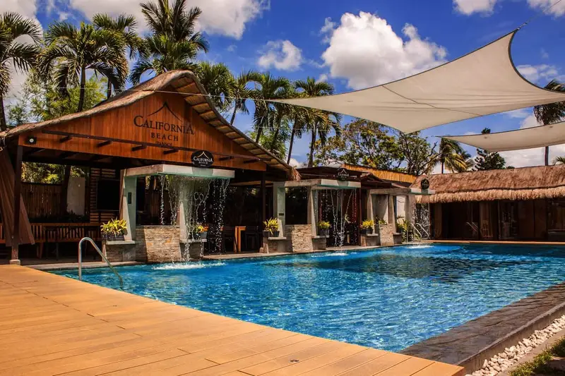 Tara Lets Anywhere feature — California Beach Pansol main pool with thatched pavilion and shade sails